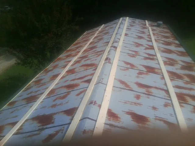 Rusted metal roof panels with new wood purlins before replacement — Storm Damage Roof Repair in Suffern by Roofing Brothers