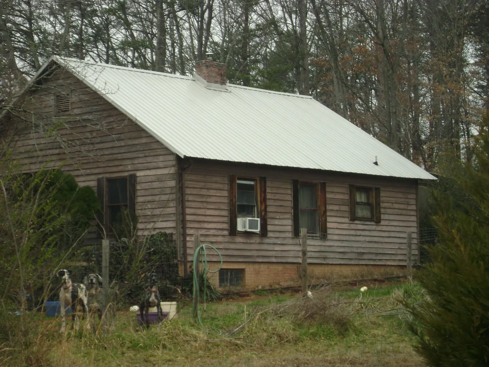 White metal roof on an old wood sided farmhouse, from a Metal Roof Installation job in Suffern